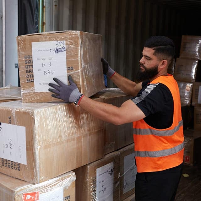 Boxzooka worker works on a B2B order