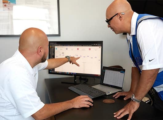 Boxzooka employees review order information on the CXP
